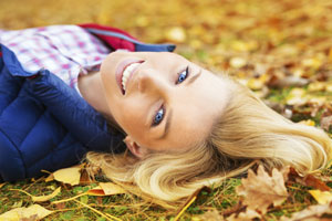 woman smiling in leaves