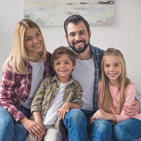 Portrait of a family smiling at home