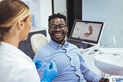Man smiling at dentist during dental checkup