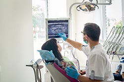 Dental hygienist using special tools to clean patient's teeth