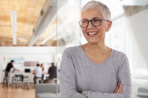 gray-haired woman smiling with dentures in San Antonio