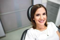 Closeup of woman smiling in emergency dentist’s office