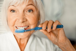 Woman brushing teeth in San Antonio