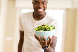 Man eating salad in San Antonio