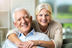 Older couple smiling with dental implants in San Antonio