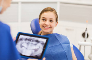 Smiling young girl in dental chair