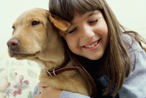 girl hugging dog