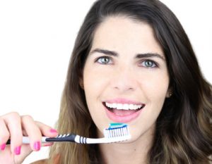 woman brushing her teeth