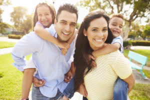 family portrait with children on parents backs