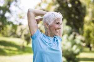 person stretching and smiling