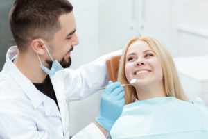 a woman smiling at her dentist