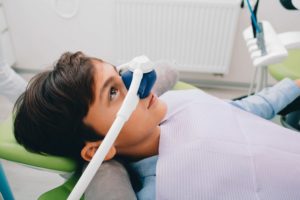 a young boy with a nitrous oxide mask