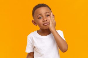 Young boy with toothache, needs to visit family dentist