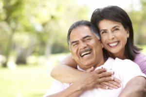 Smiling couple with dental implants in San Antonio