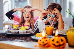 children having fun during Halloween and eating candy