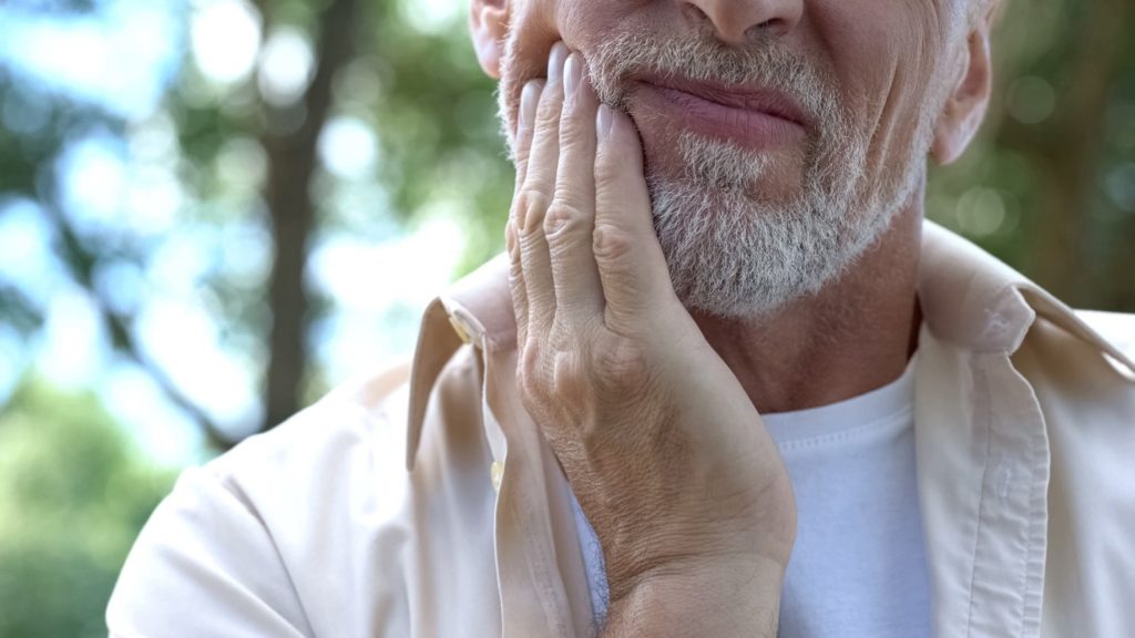 Closeup of senior man experiencing tooth pain