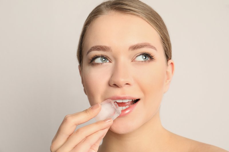 a woman prepares to eat a piece of ice