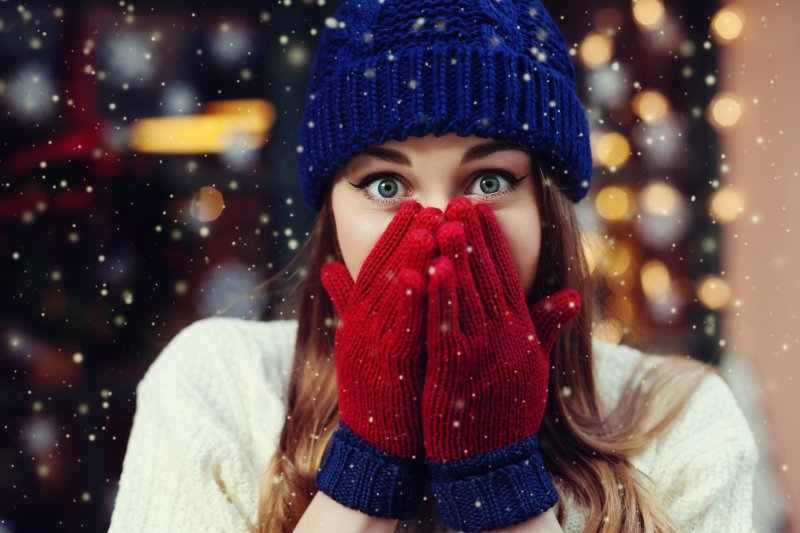 a woman covering her winter mouth issues in San Antonio