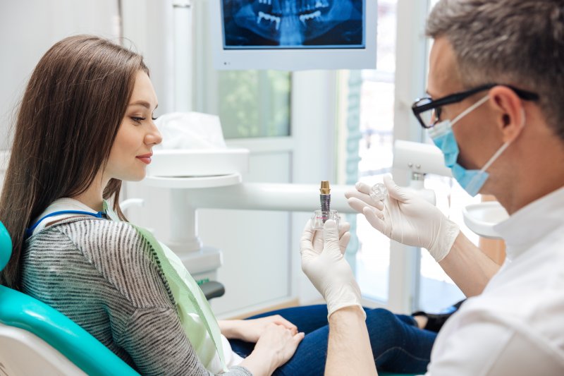A dentist explaining the sources of dental implant success