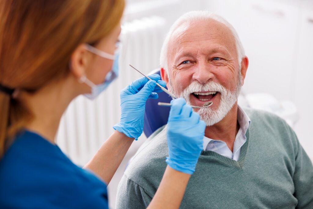 Mature man smiling during dental checkup