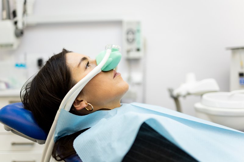 A woman receiving dental sedation